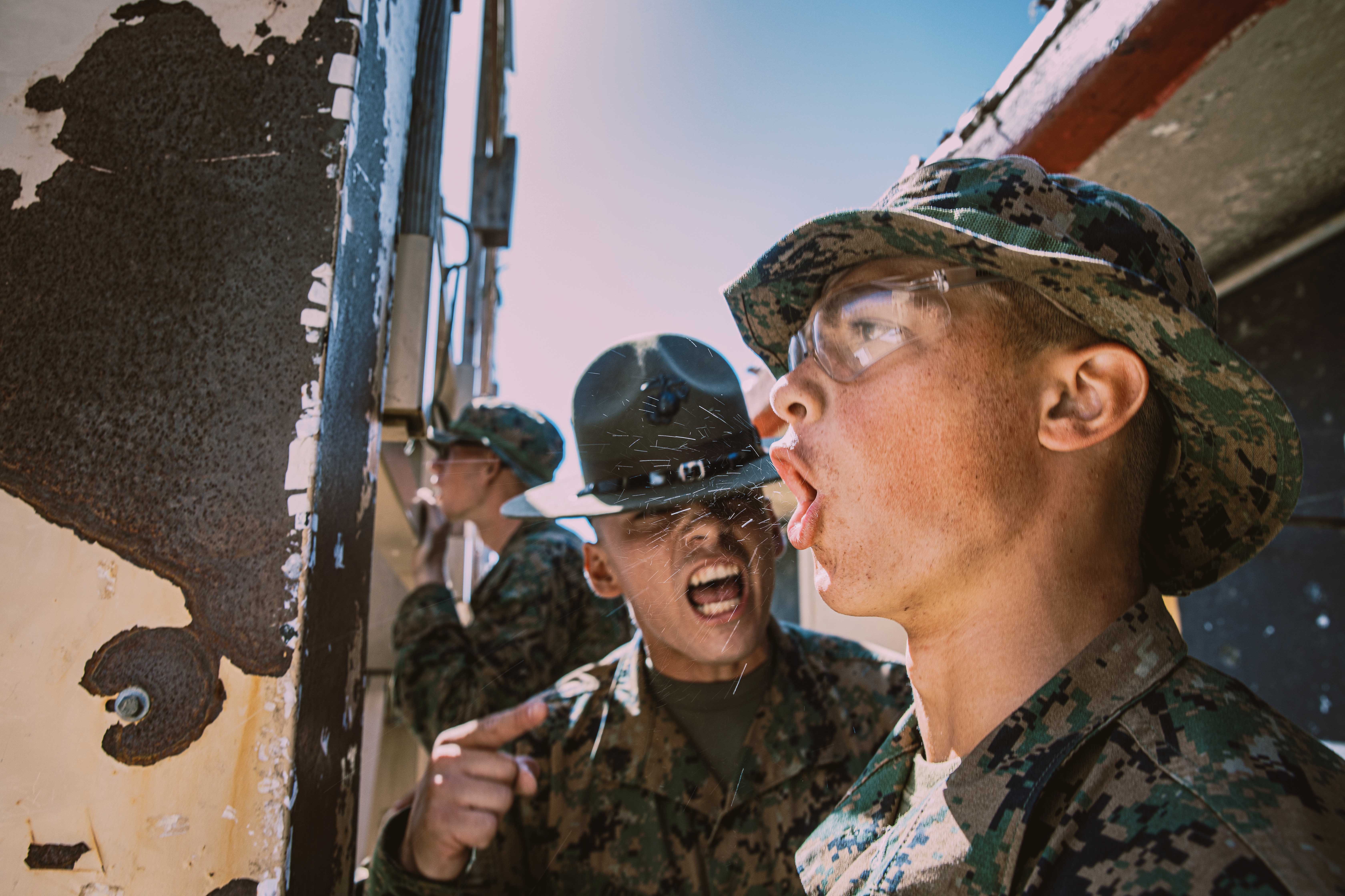 U.S. Marine Corps Sgt. and drill instructor with Fox Company, 2nd Recruit Training Battalion, corrects a recruit during the table one course of fire at Marine Corps Base Camp Pendleton, California, Aug. 21, 2024. The table one course of fire is designed to introduce recruits to the basic fundamentals of marksmanship and rifle safety. (U.S. Marine Corps photo by Cpl. Sarah M. Grawcock.)